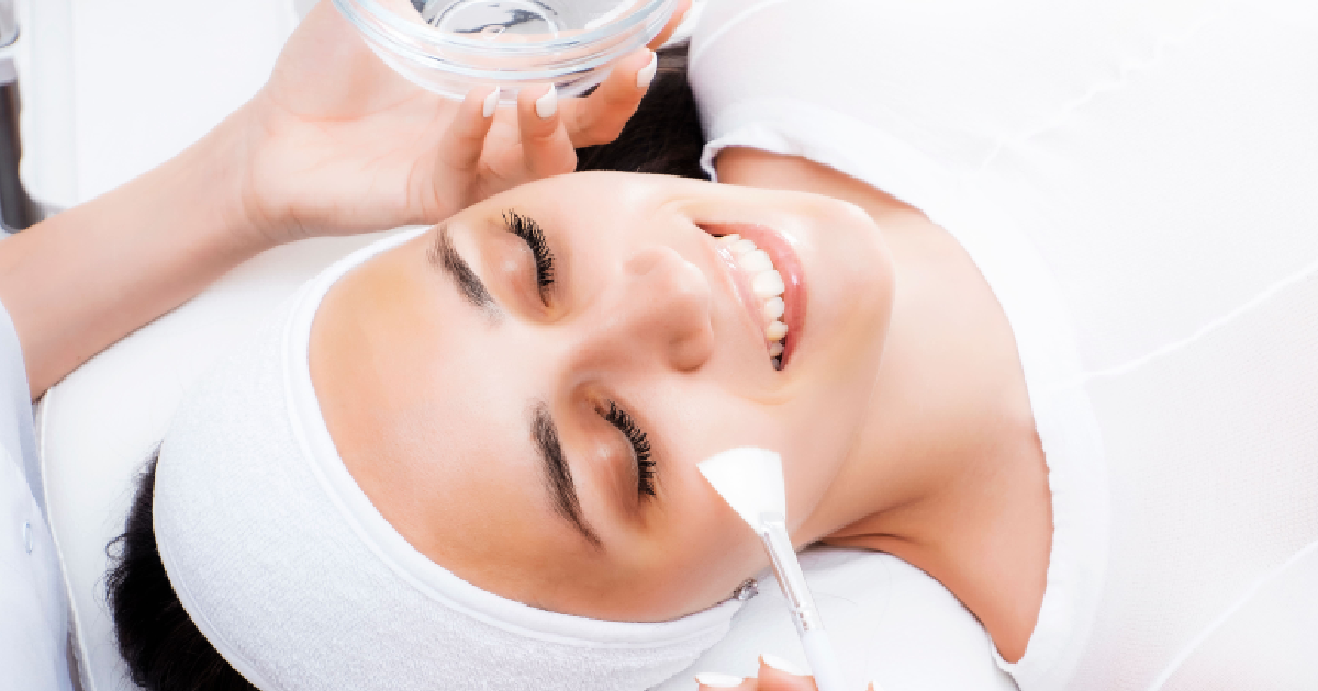 Professional applying a Chemical Peel solution to a woman's skin, representing Chemical Peel in Lakewood CO for clearer, smoother skin.